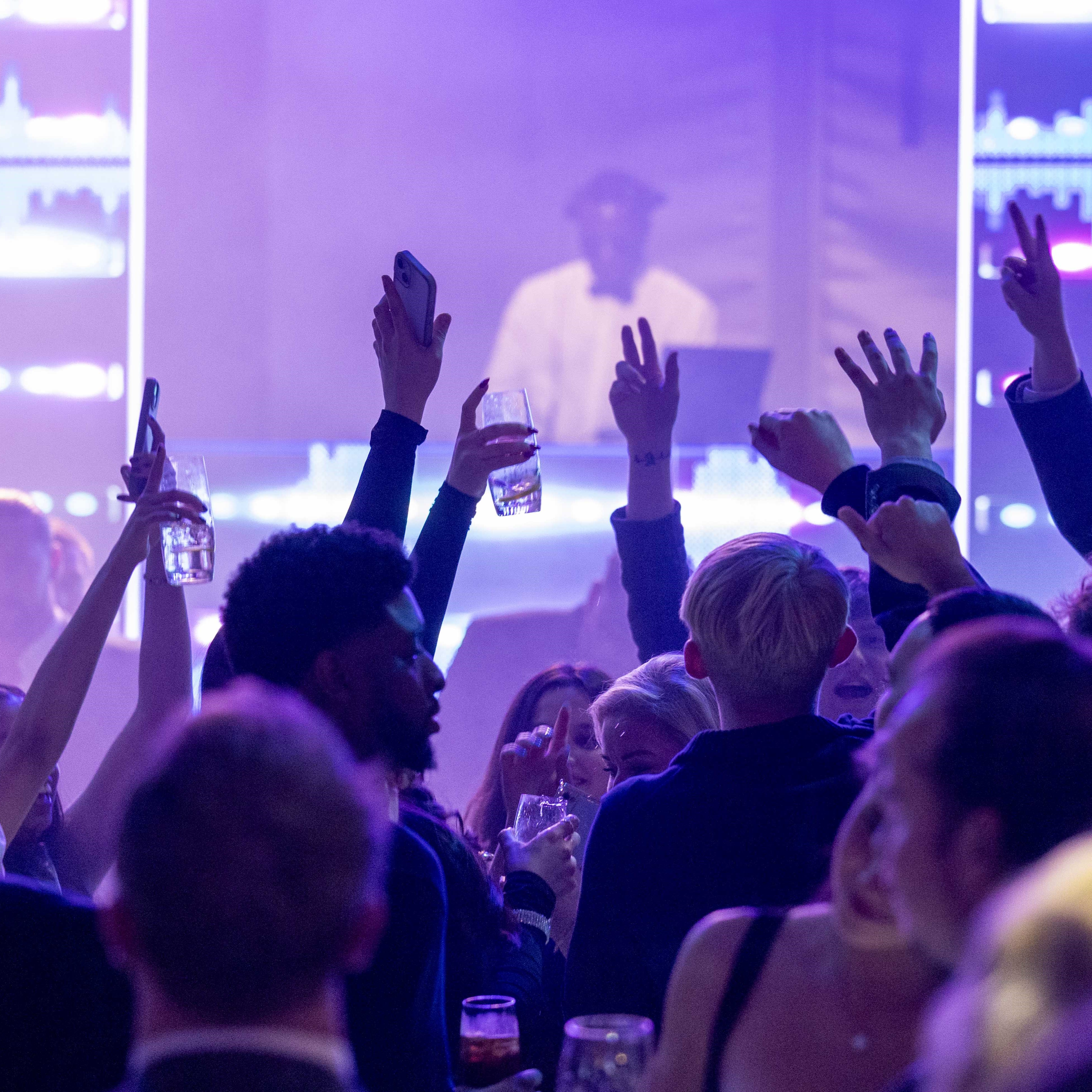 "Christmas party at Tottenham Hotspur Stadium with lively attendees celebrating and networking." - Banner