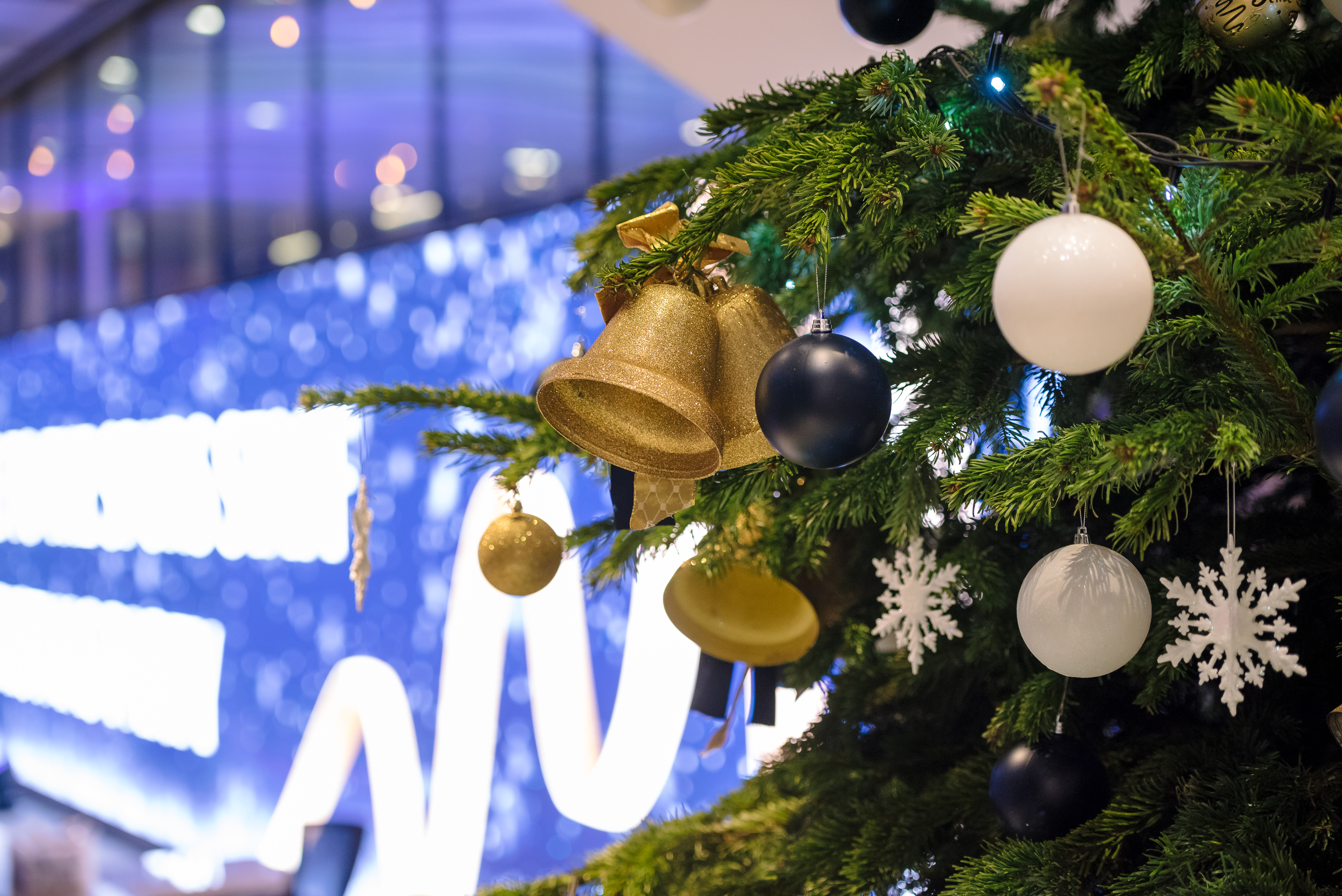 Christmas tree with gold ornaments at Tottenham Hotspur Stadium holiday event. - Banner