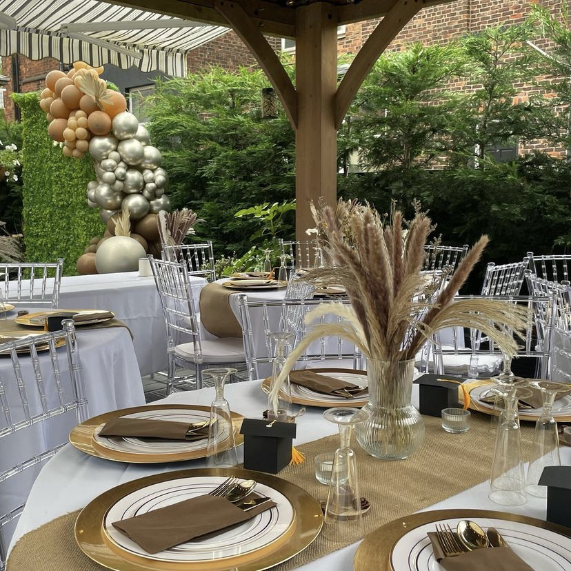 Elegant outdoor event space with pampas grass centerpieces for weddings and corporate events. - Banner