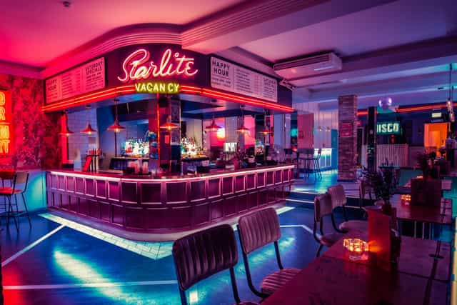Vibrant Simmons Bar with neon lights, ideal for networking and social events.