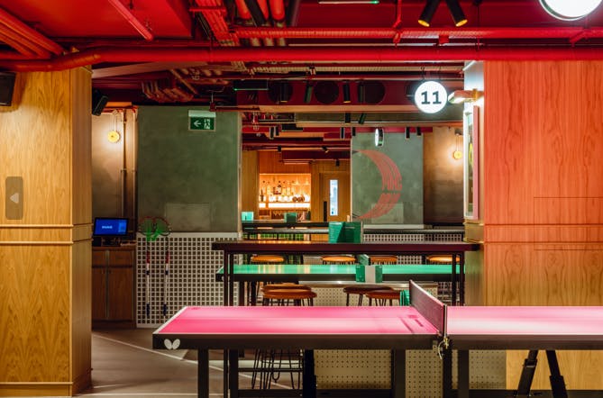 Vibrant conference space with ping pong tables for meetings and networking events.