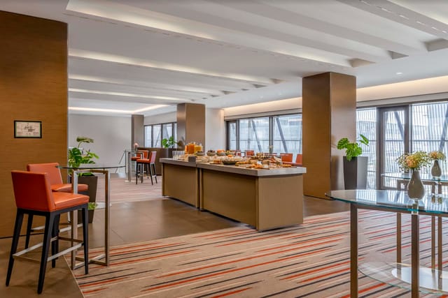 Modern event space at Sheraton Zurich with buffet setup, perfect for corporate meetings.