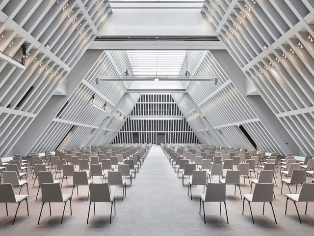 Modern Convention Hall with natural light, ideal for conferences and presentations.
