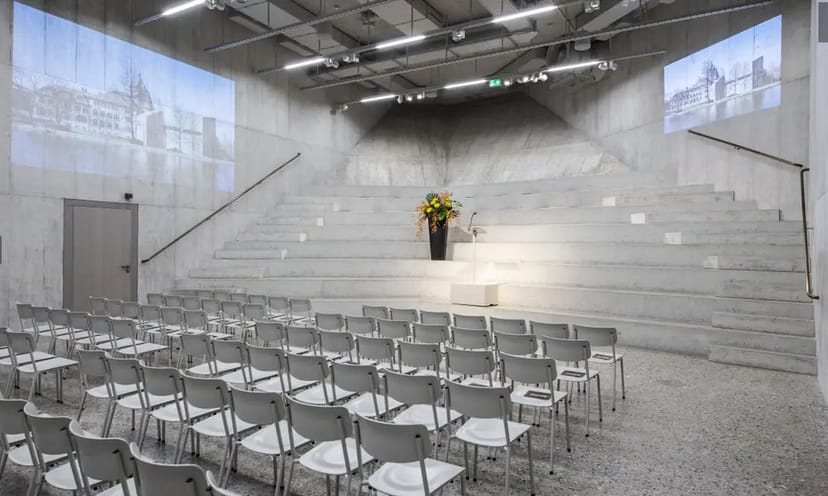 Modern auditorium with tiered seating for corporate meetings and conferences in Zurich.