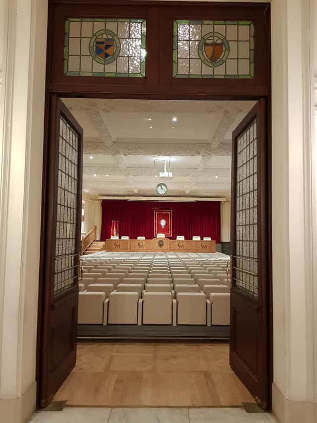Elegant event space with arranged seating and stage at Casino de Madrid for conferences.