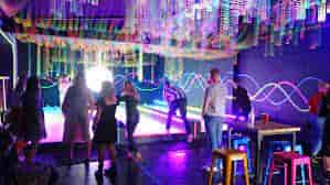 Neon-lit experiential event space at The Floodgate for corporate mixers and branded social parties.