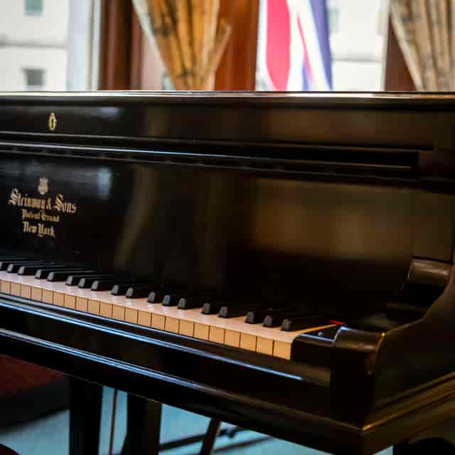 David Lloyd George Room with polished grand piano, perfect for receptions and gala dinners.