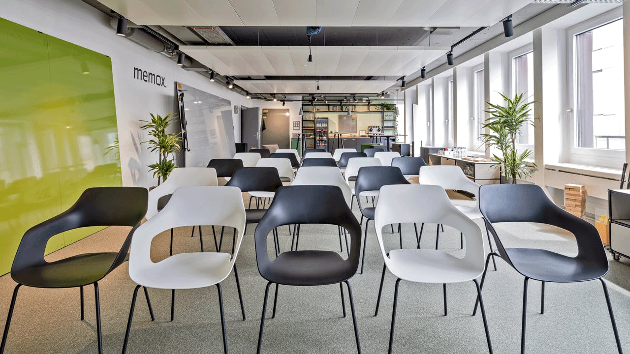 Modern meeting space with minimalist chairs, ideal for workshops and presentations.