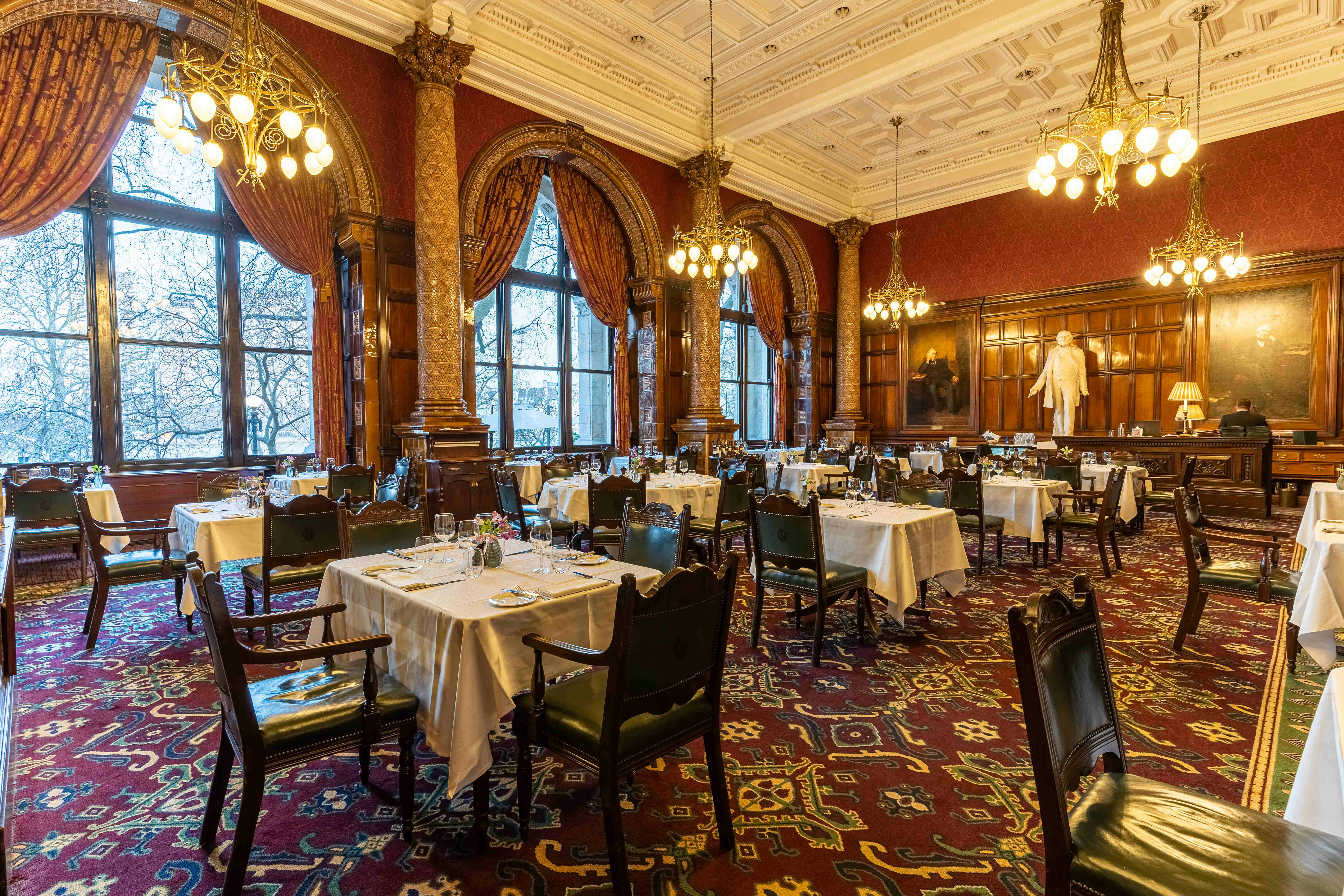 Elegant dining room with chandeliers, ideal for upscale events and meetings.