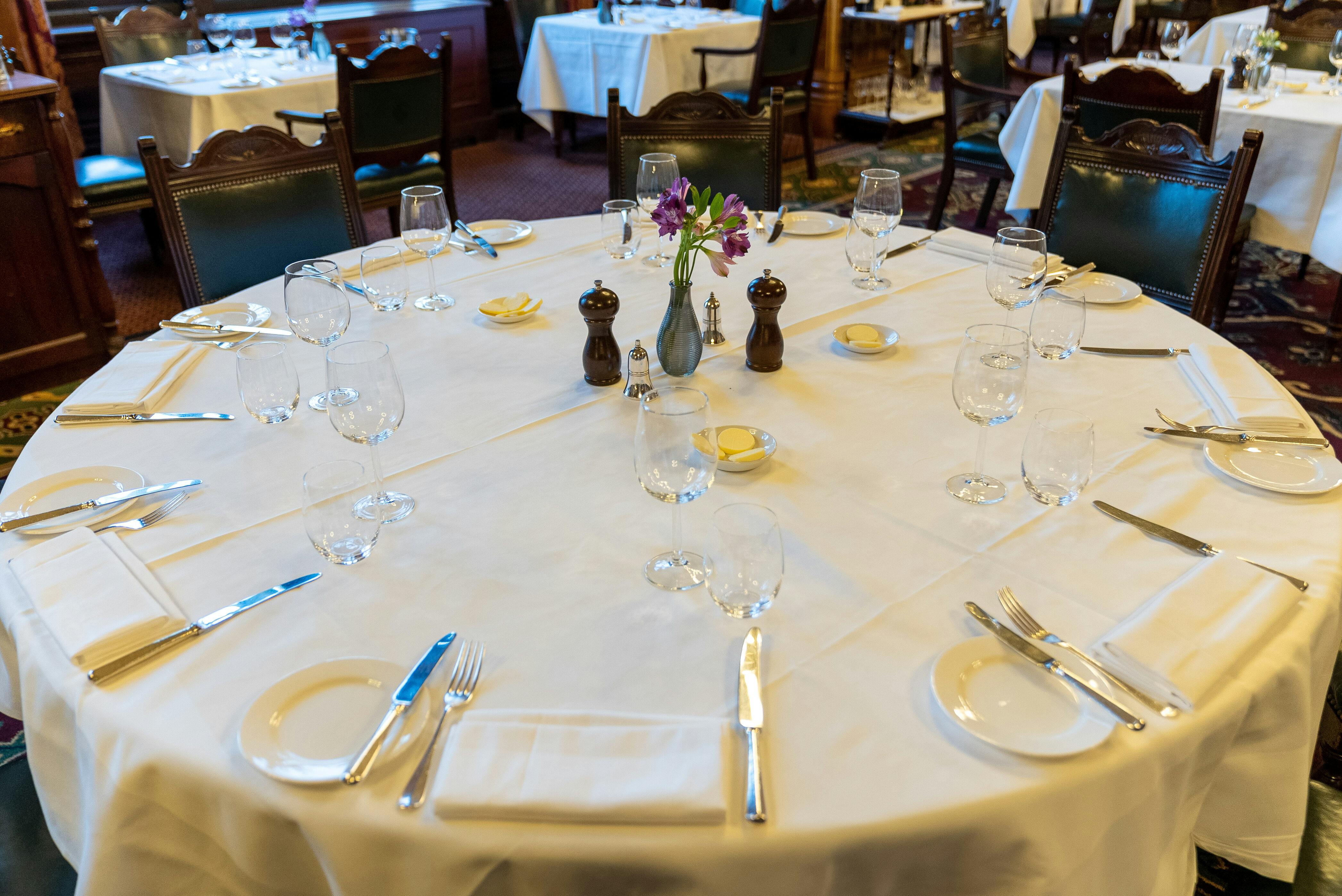 Elegant round dining table setup at The National Liberal Club for formal events.