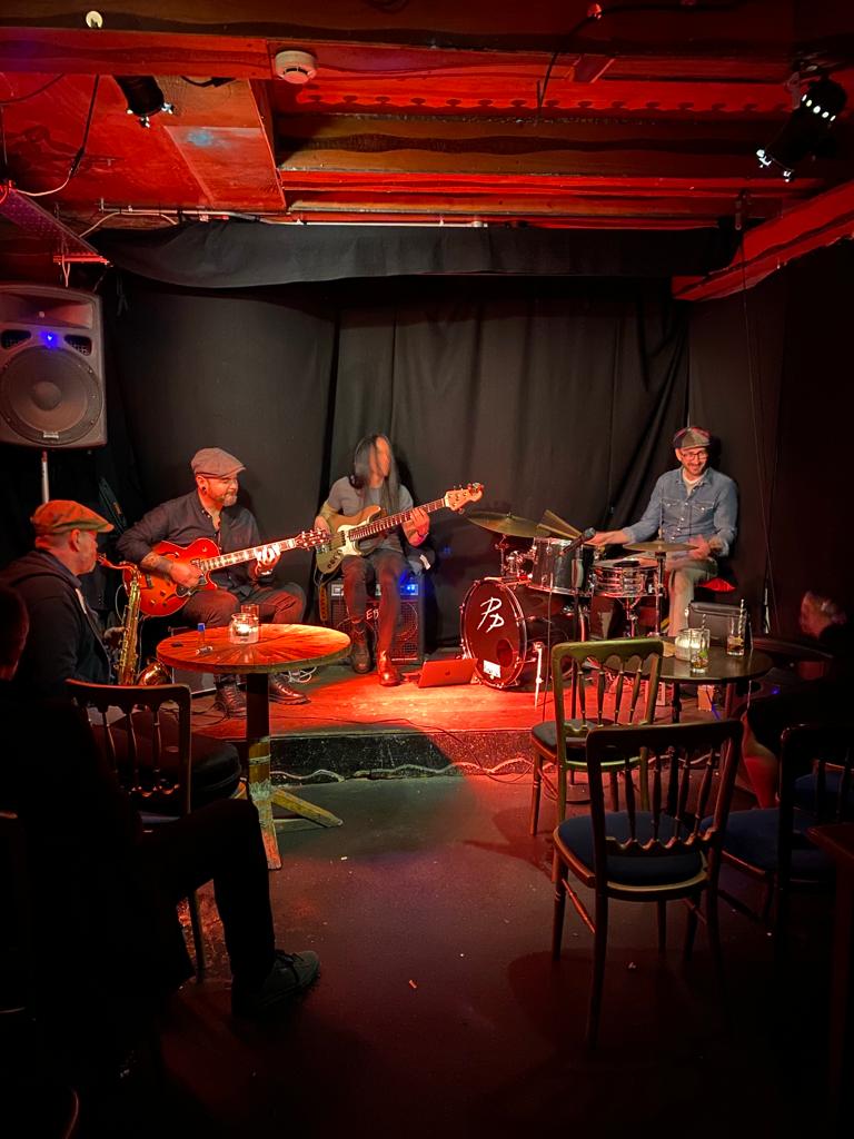 Cozy live music setting in Hoxton Cabin Basement for intimate gatherings and events. - Banner