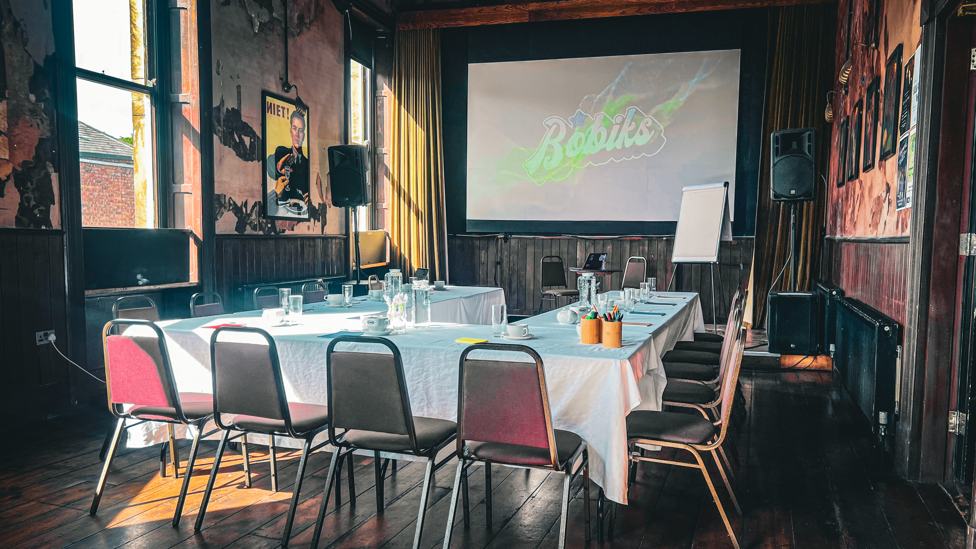 "Meeting space with large screen, seating for collaboration, ideal for workshops and events." - Banner
