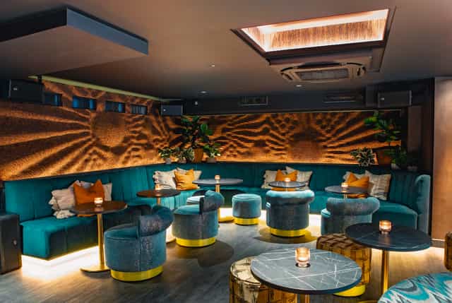Chic lounge event, textured wall art, cocktail reception, VIP gathering