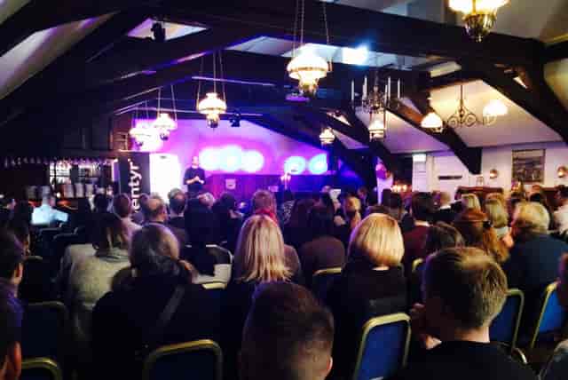 Engaged audience at Neptunisalen, Sjofartshuset, during a presentation event.
