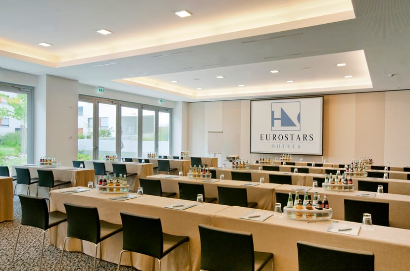 Corporate meeting room at Eurostars Grand Central with natural light and presentation screen.