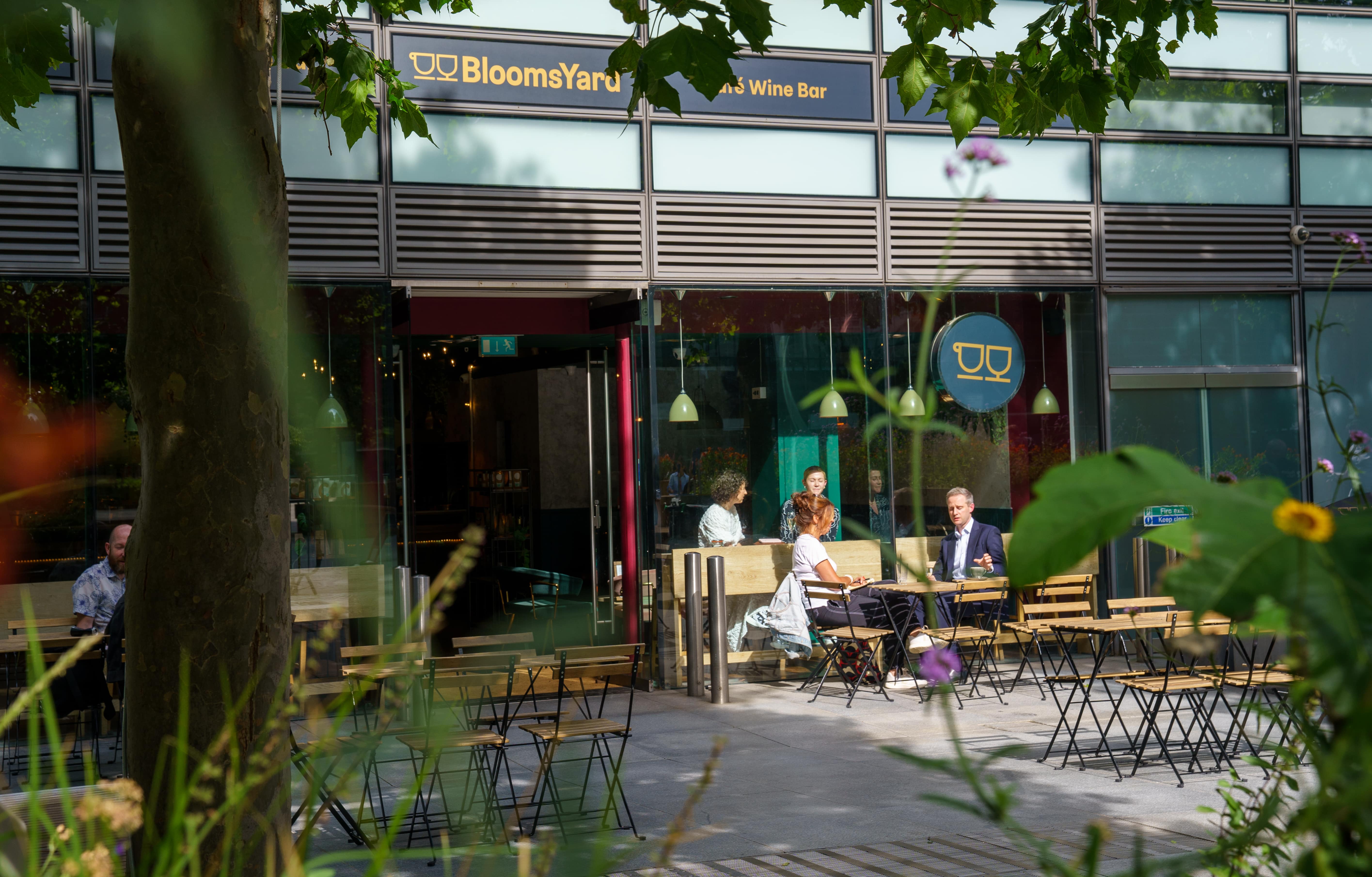 Vibrant outdoor seating at BloomsYard wine bar, perfect for networking events. - Banner