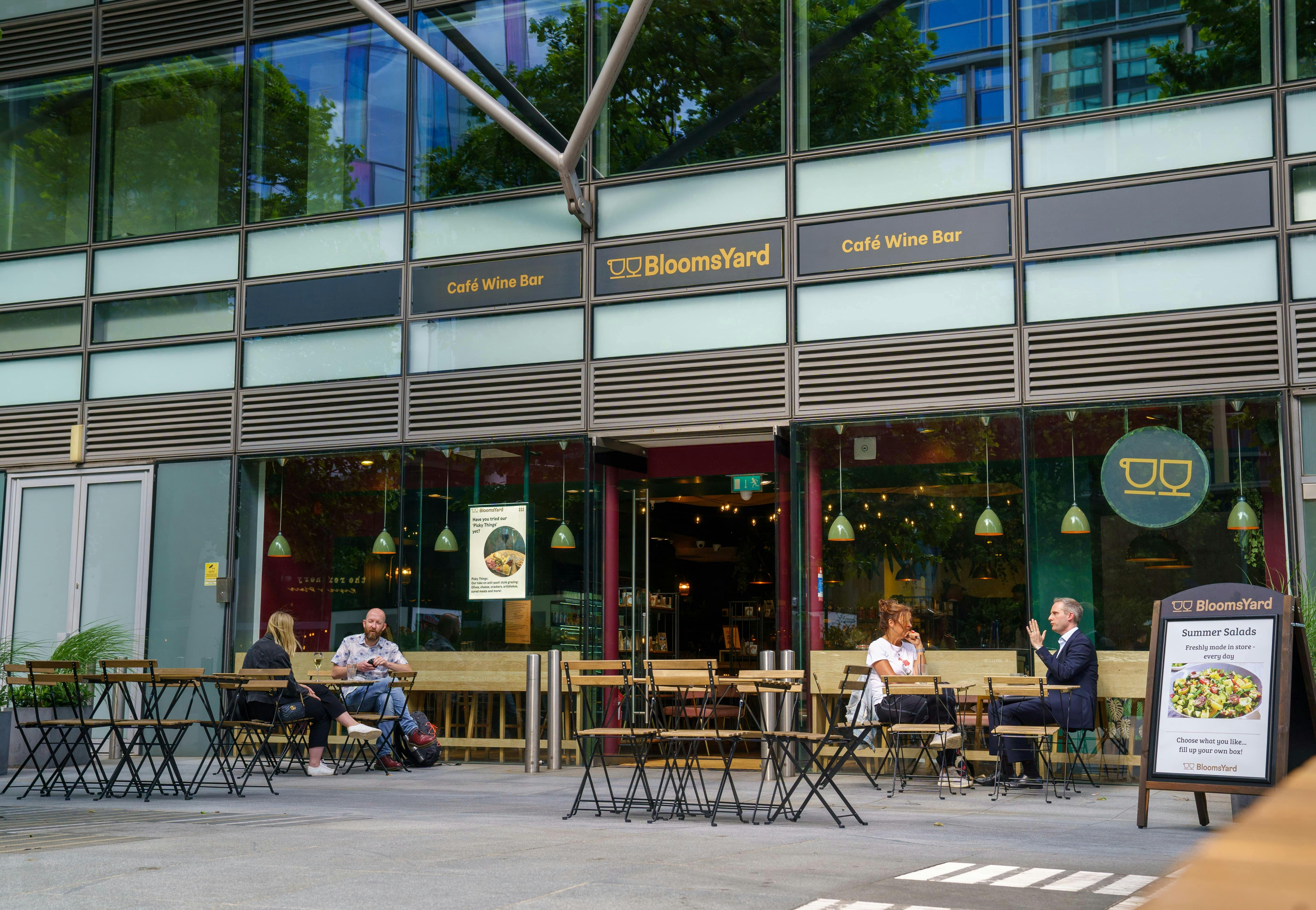 Vibrant outdoor seating at BloomsYard wine bar, perfect for casual meetings and networking.