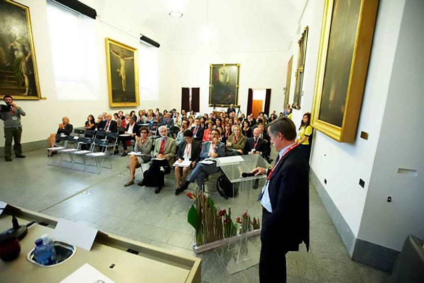 Conference in Sala delle Accademie, Ambrosiana with elegant decor and engaged audience.
