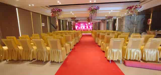 Elegant event space at Hotel Gagan Plaza with golden chairs and red carpet for formal gatherings.