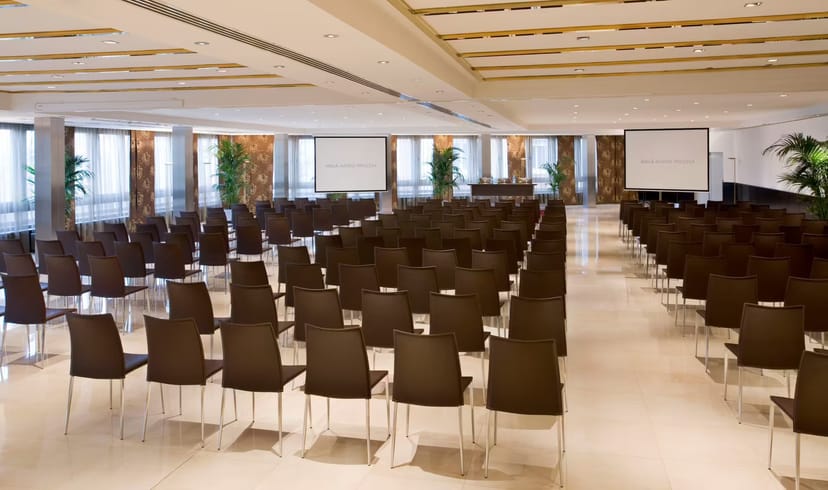 Spacious conference room with modern chairs for events at Meliá Madrid Princesa.