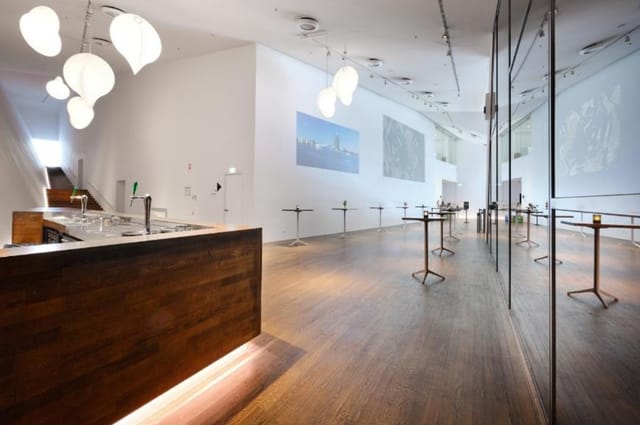 Modern event space in Eye Film Museum with polished wooden bar, ideal for receptions.