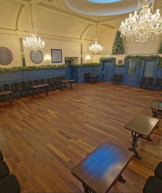 Spacious sports bar venue with polished floors, ideal for meetings and gatherings.