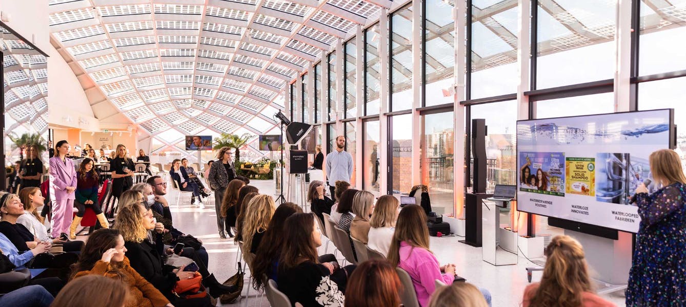 Engaged audience at The High Light event in a modern, light-filled venue.
