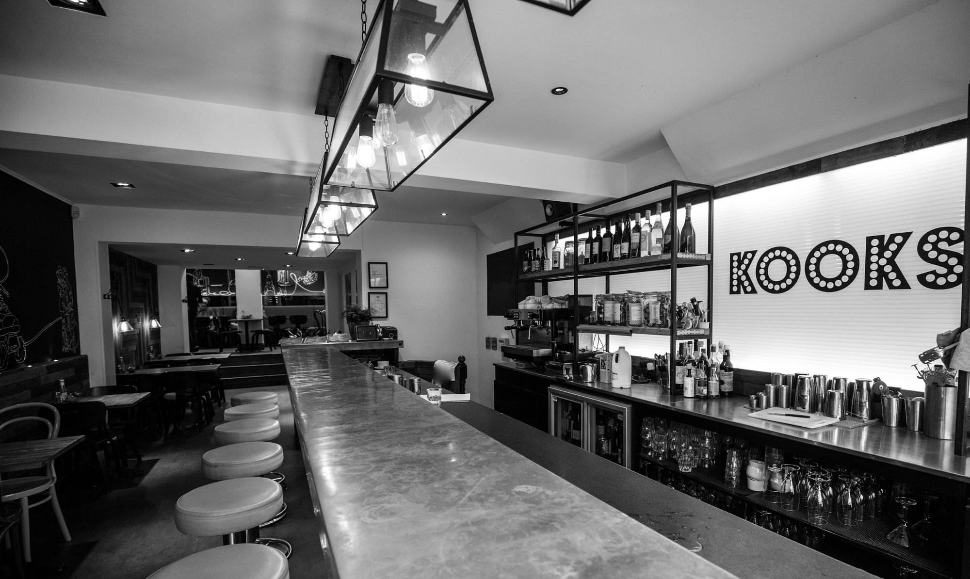 Sleek bar at Kooks Restaurant, perfect for cocktail receptions and networking events.