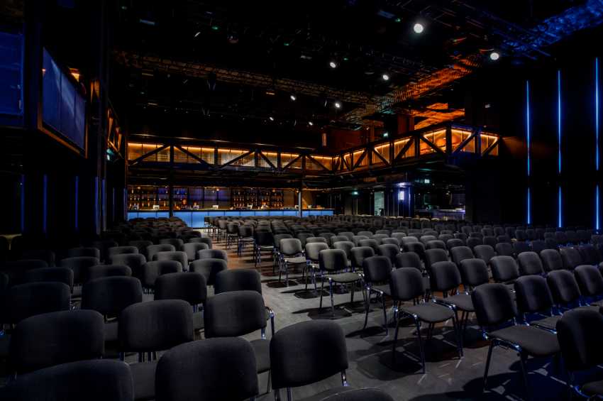 Versatile event space in London with sleek chairs for conferences and presentations. - Banner