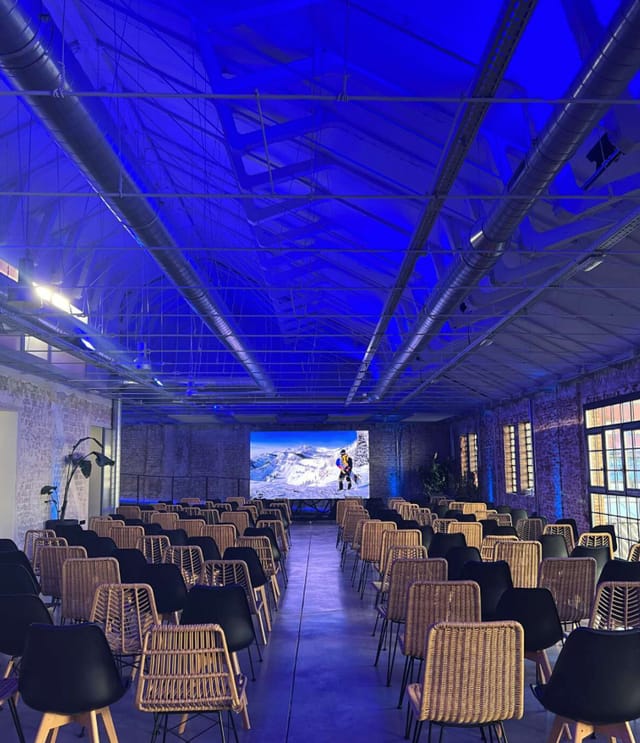 Modern event space with blue lighting, ideal for conferences and workshops.