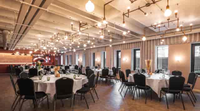 Elegant event space with round tables, ideal for formal dinners and networking.