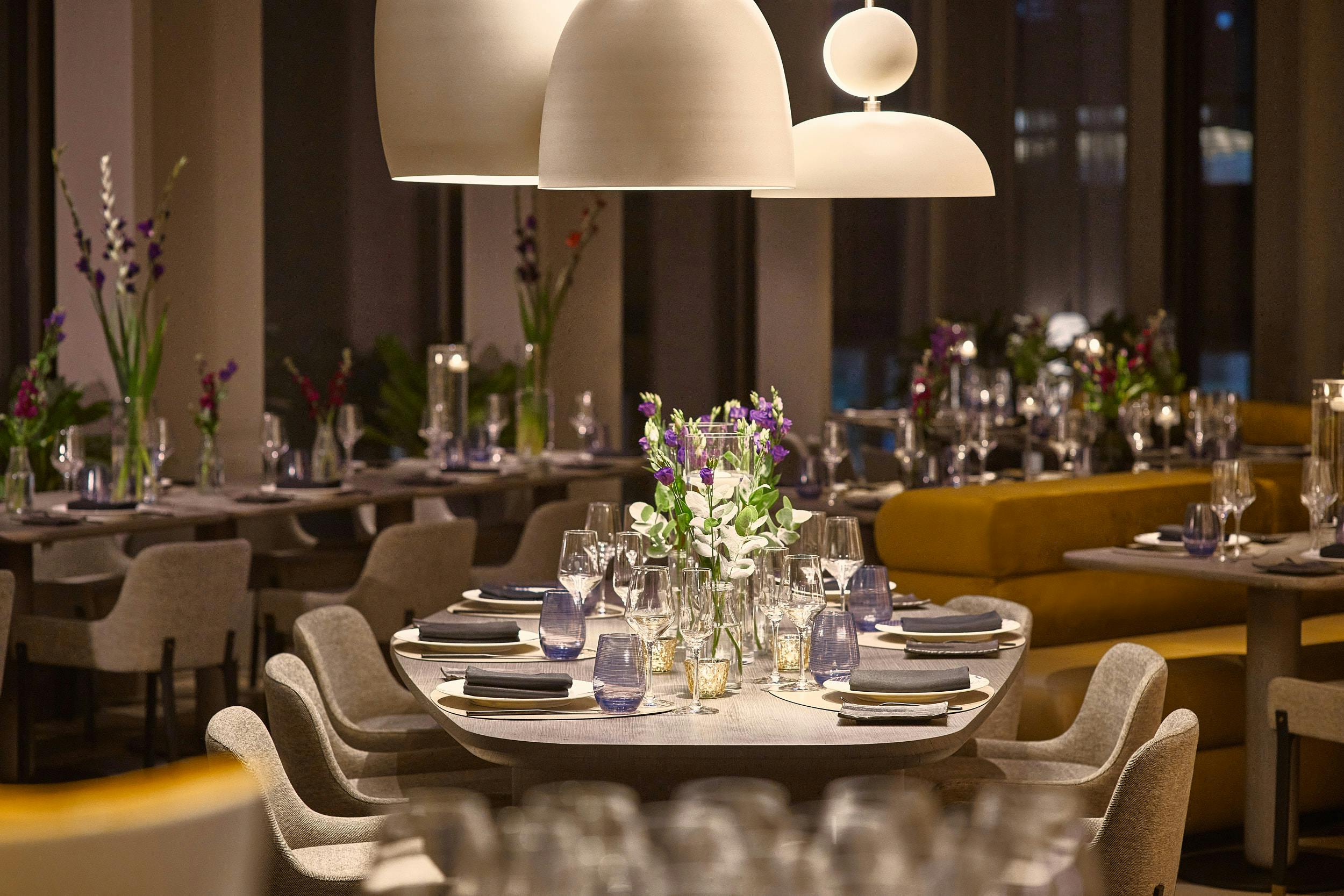 Sophisticated dining setup with floral centerpieces for corporate events in Pan Pacific London.