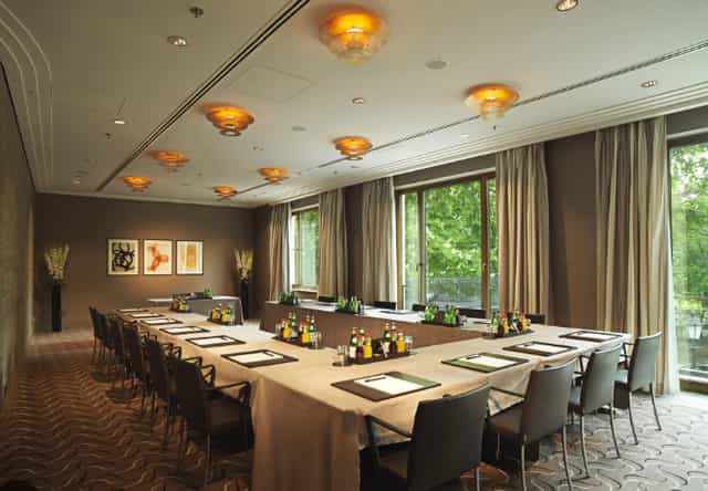 Meeting room at The Charles Hotel with natural light, ideal for corporate events.
