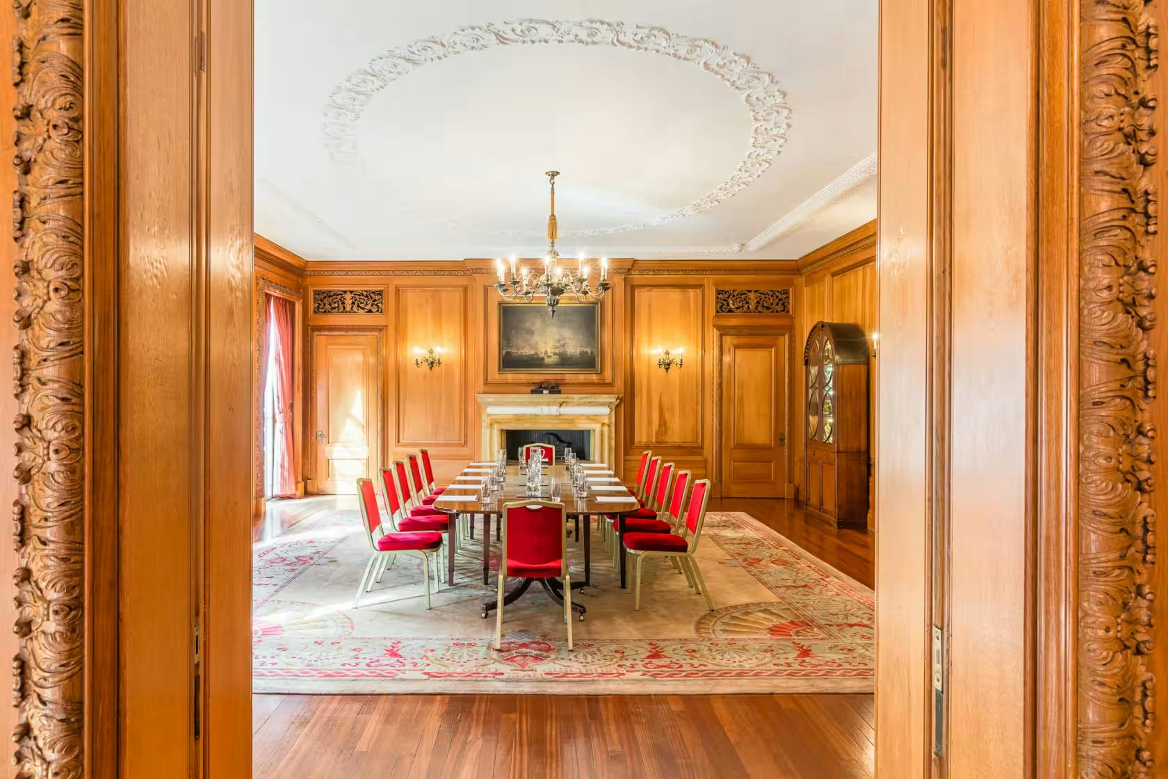 Elegant meeting room with wood paneling, ideal for corporate events and discussions.