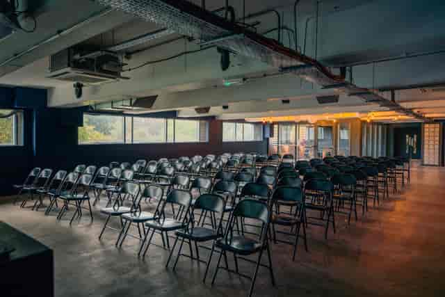 Versatile event space in Peckham Levels with black chairs for presentations and seminars.