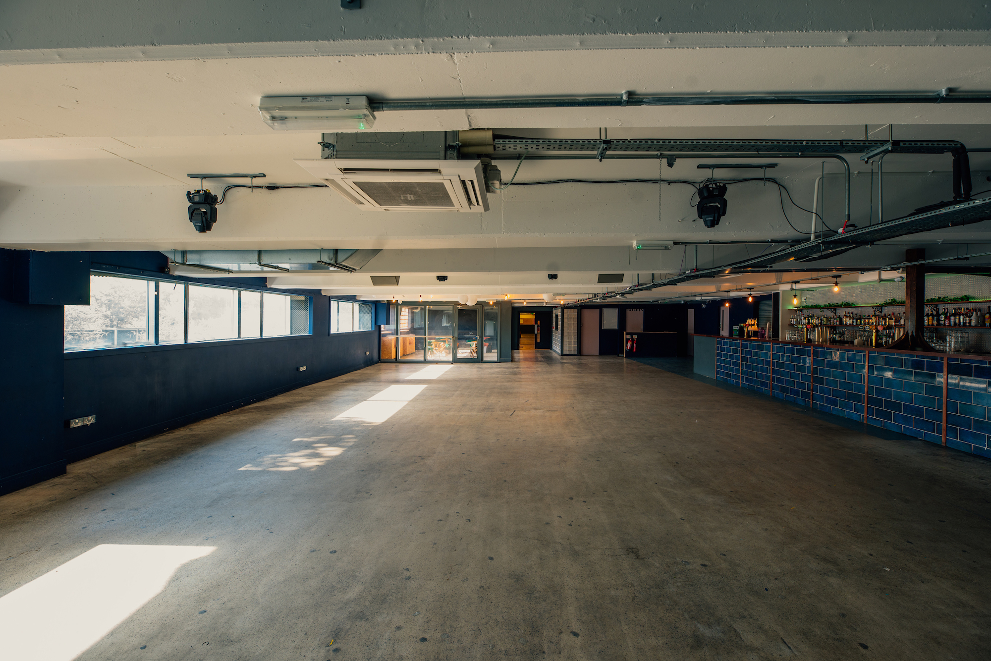 Spacious event venue in Peckham Levels with natural light for meetings and workshops. - Banner