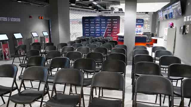 iFLY Indoor Skydiving event space with black chairs for presentations and discussions.