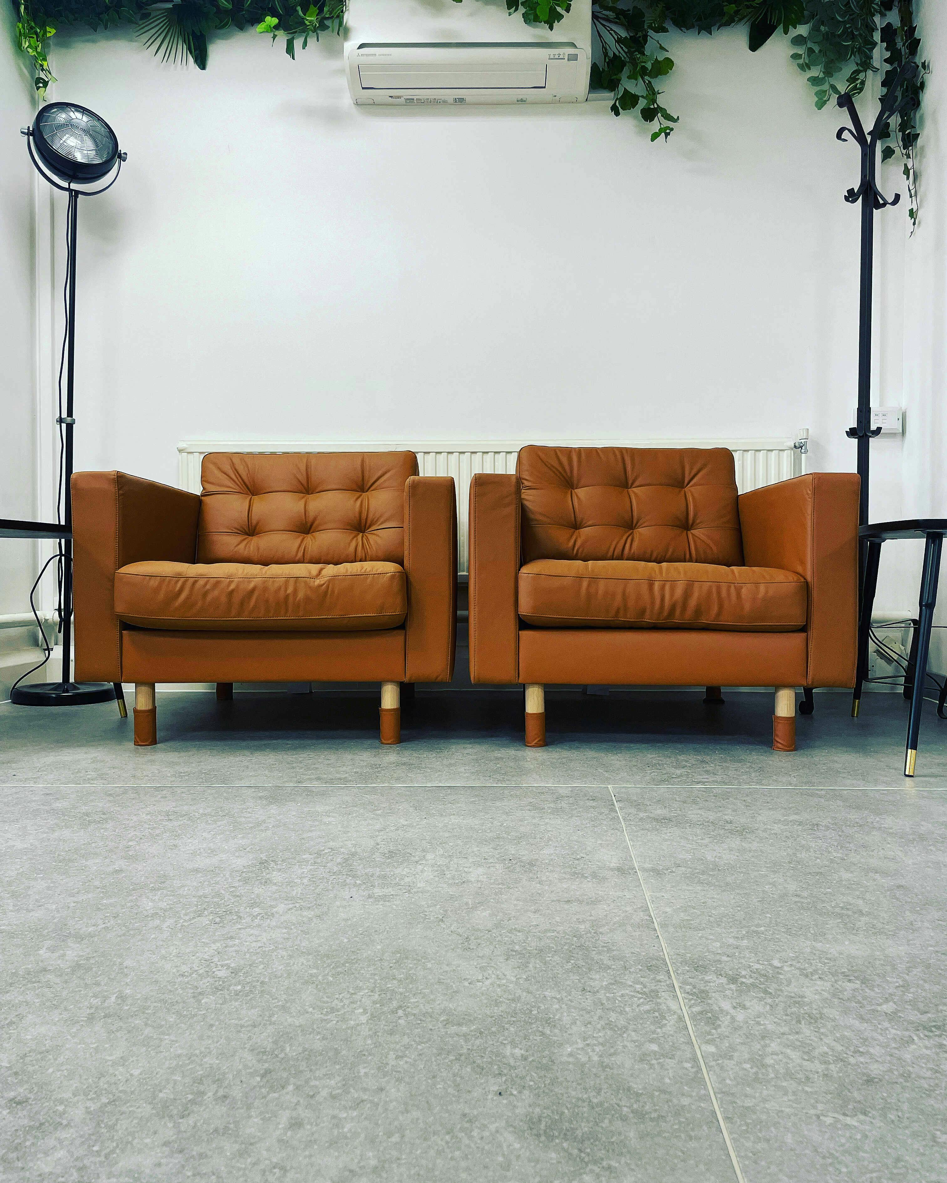 Modern brown armchairs in Wanstead Works, ideal for networking and meetings.