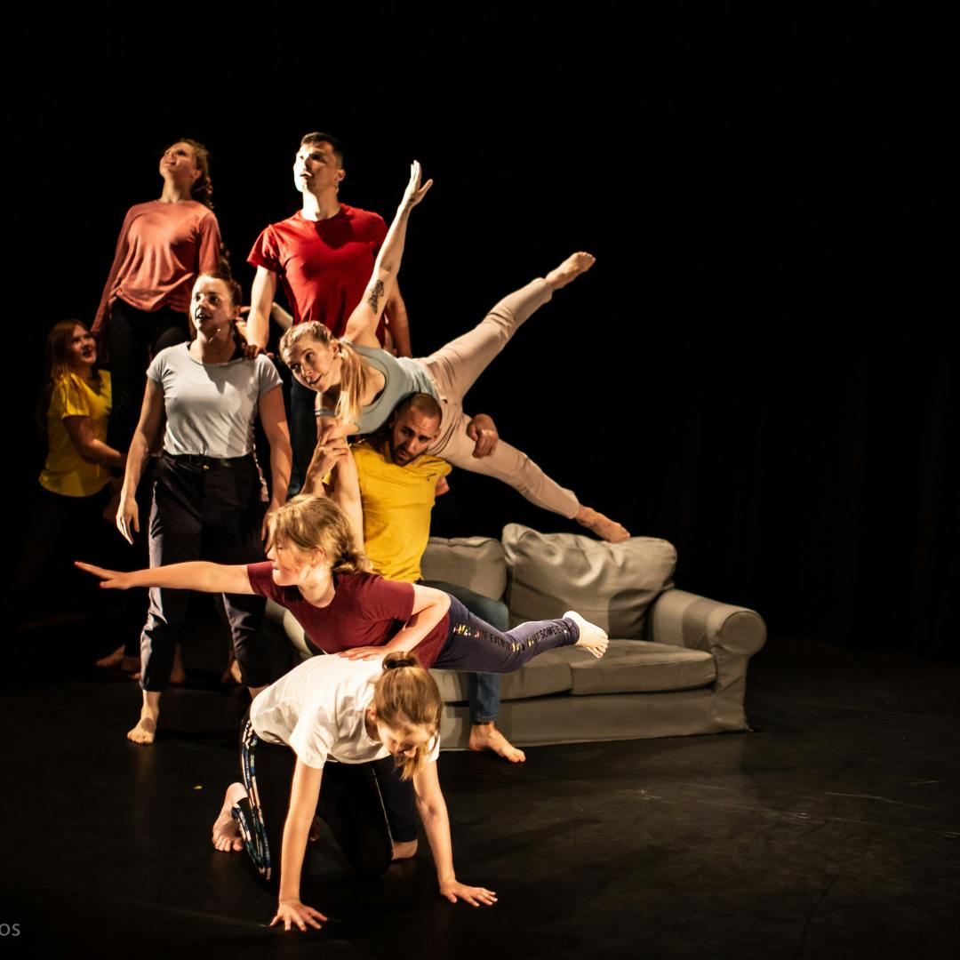 Dynamic performance with performers and couch, ideal for creative event entertainment.