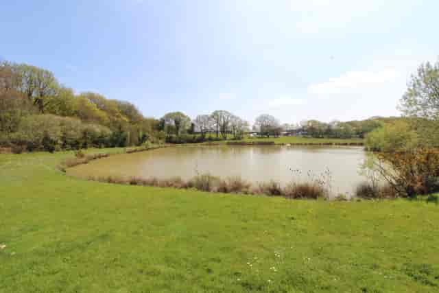 Serene HHE Showground venue with tranquil pond for corporate retreats and team-building events.