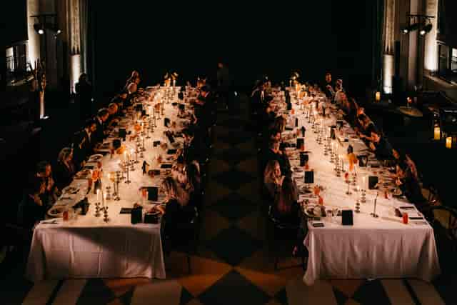 Elegant long-table setup in Banking Hall for a sophisticated corporate banquet or gala dinner.