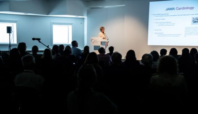 Engaging speaker at British Cardiovascular Society conference room session.