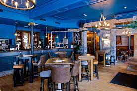 Stylish venue with vibrant blue interior, ideal for networking and corporate events.