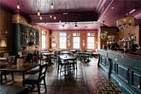 Stylish venue with warm lighting, ideal for networking events and workshops.