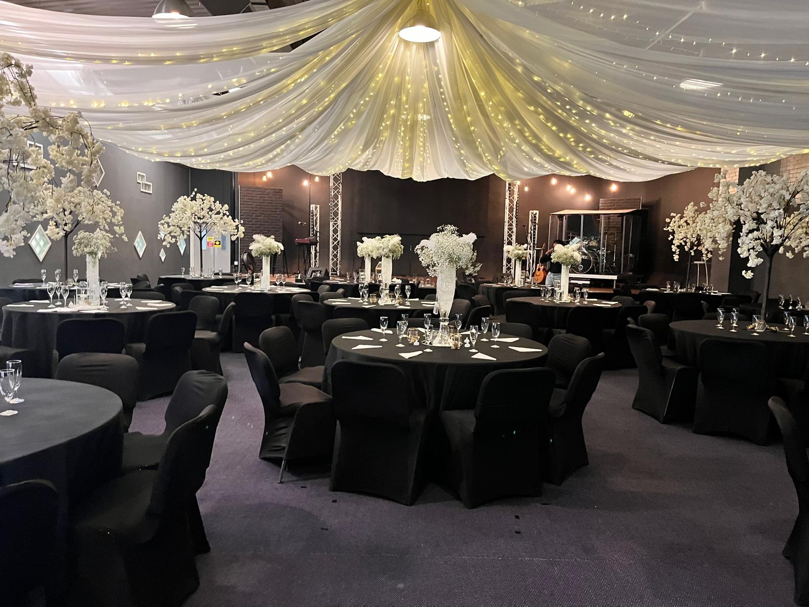 Elegant function hall with floral centerpieces, ideal for weddings and corporate events.