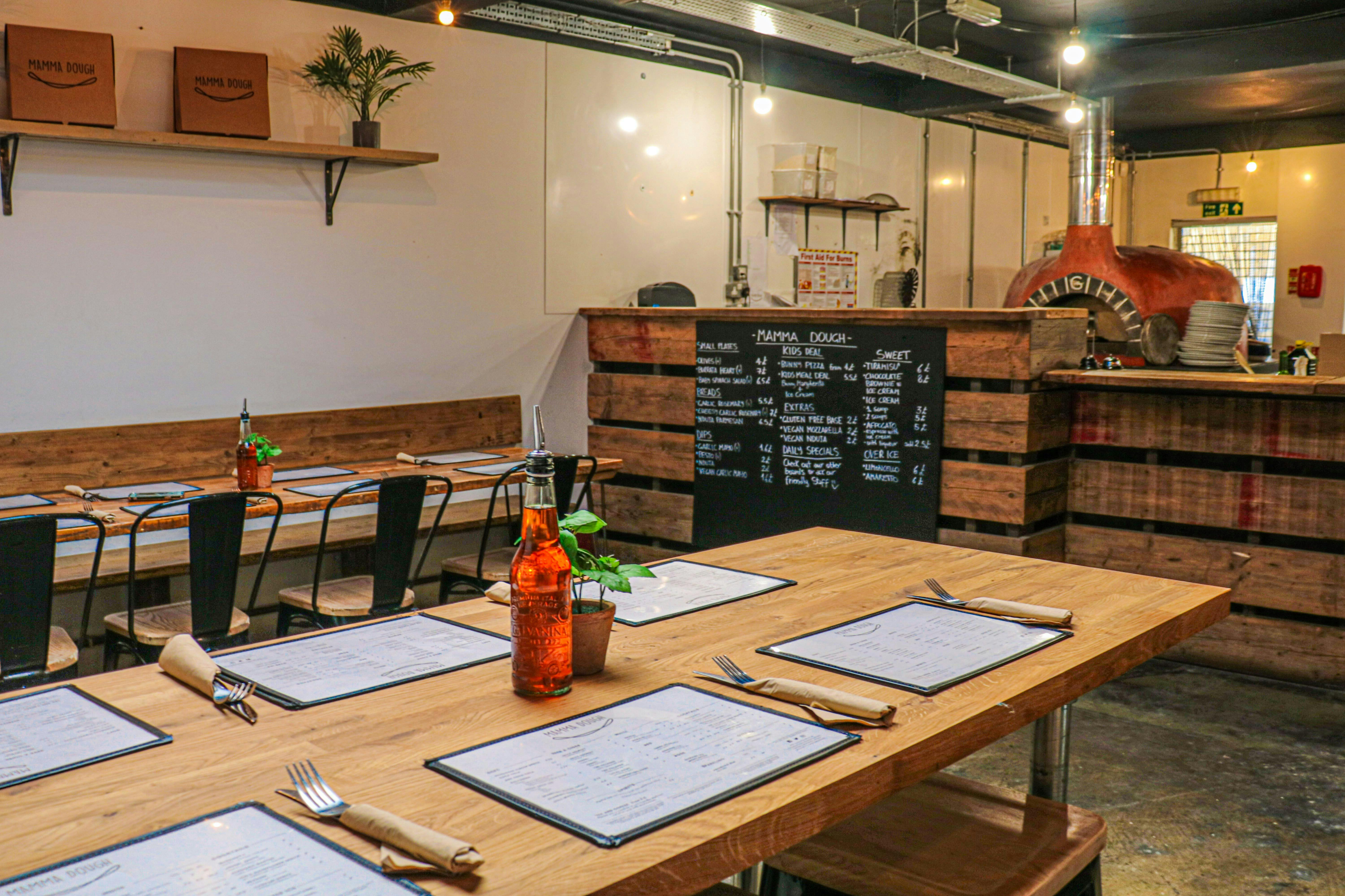 Pizza Parlour dining space with rustic decor, perfect for gatherings and networking events.