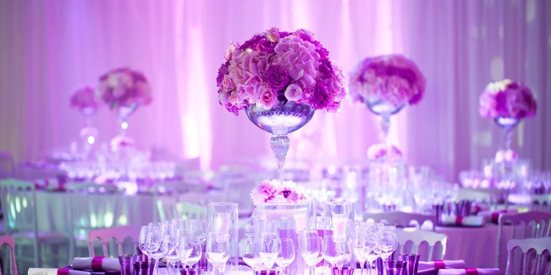 Elegant Queen Mary Junior Ballroom with floral centerpieces for weddings and corporate events.