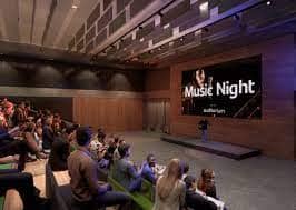 Auditorium in Unity Place set for Music Night with tiered seating and stage presentation.