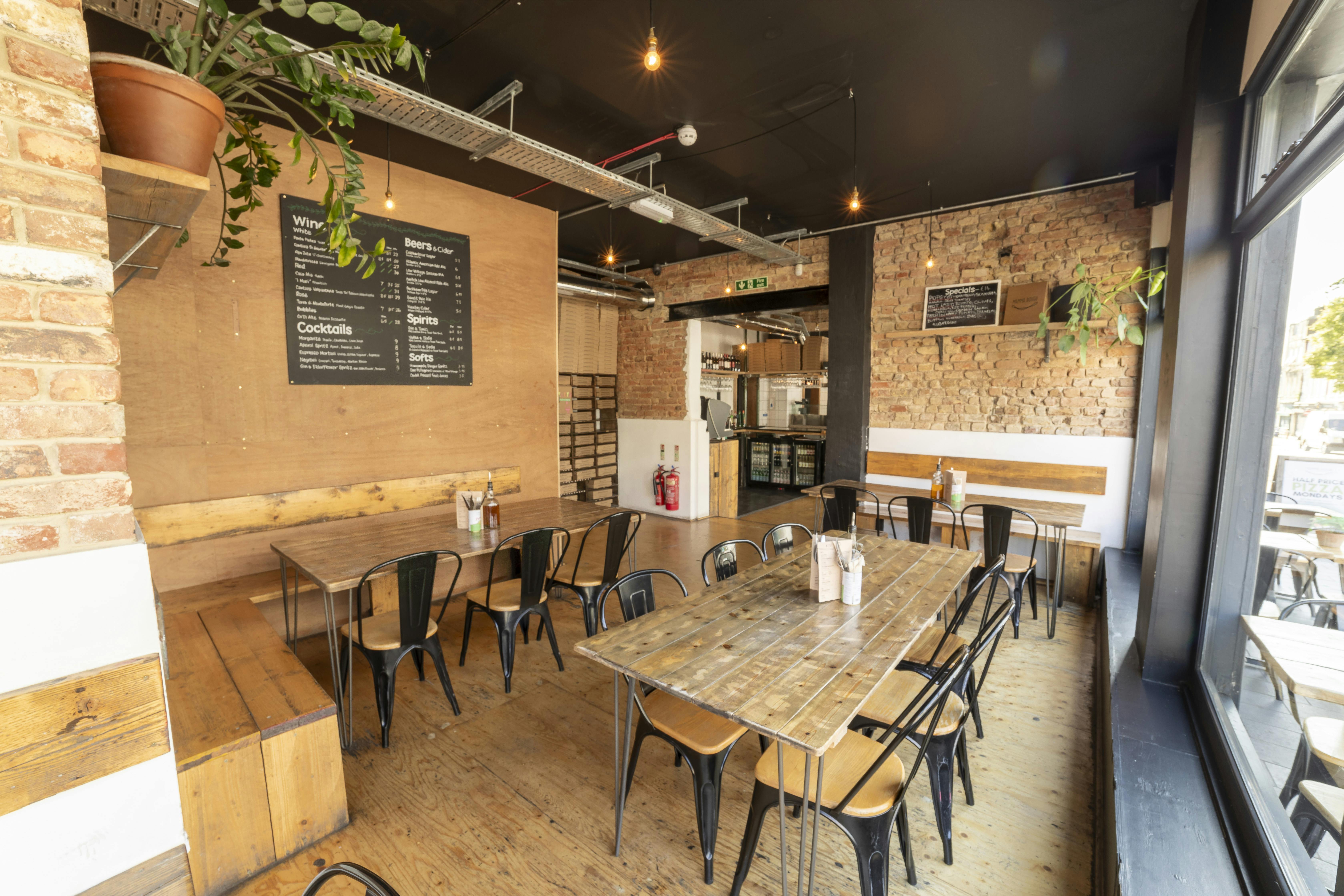 Versatile event space in Mamma Dough South Norwood with exposed brick, ideal for workshops.