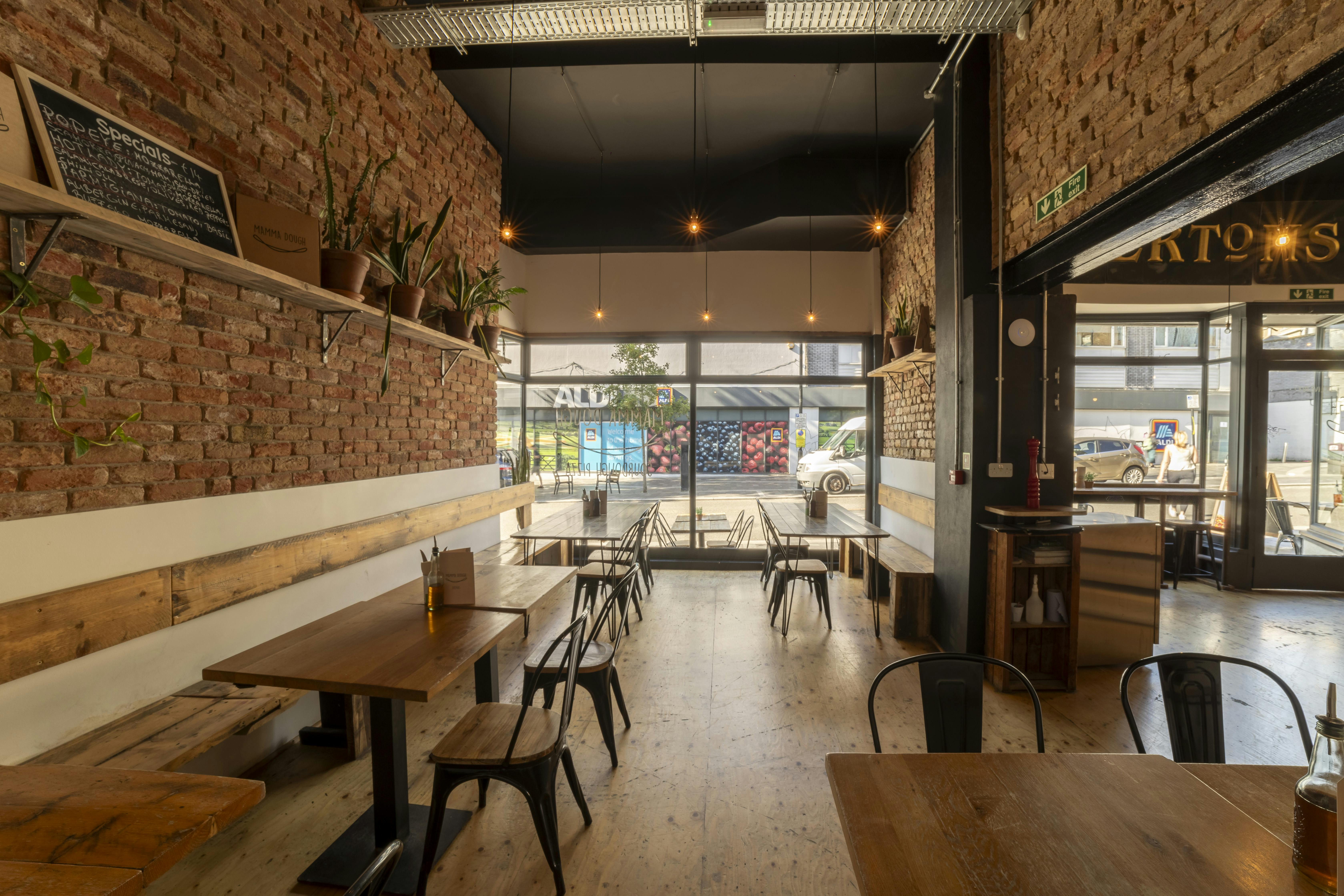 Versatile event space with exposed brick walls, ideal for networking and workshops.